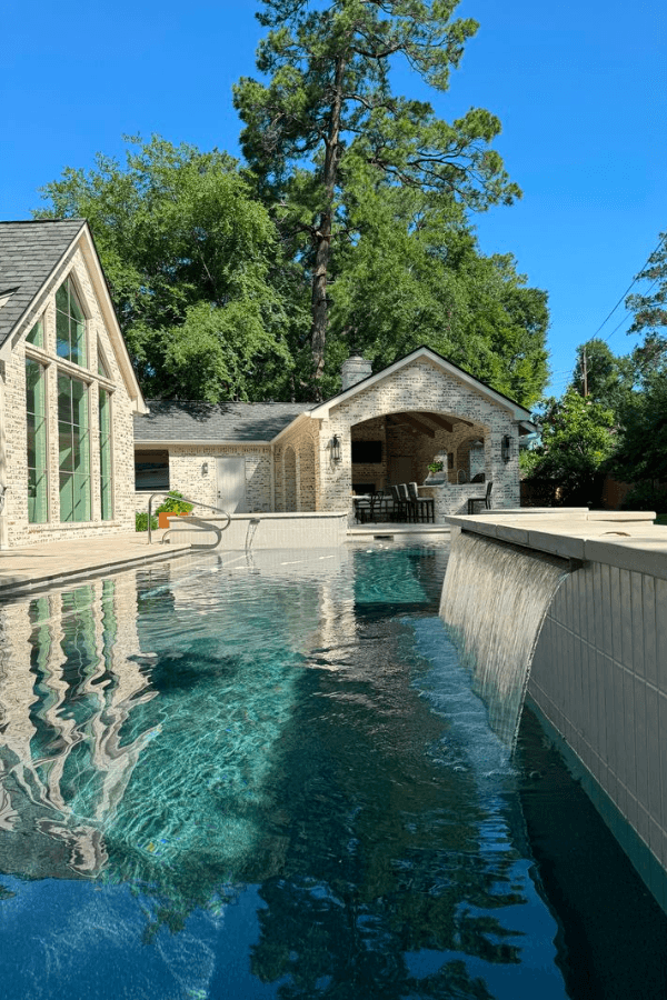 Custom freeform pool with spa and travertine deck - SGV Pool Maintenance Charlotte NC